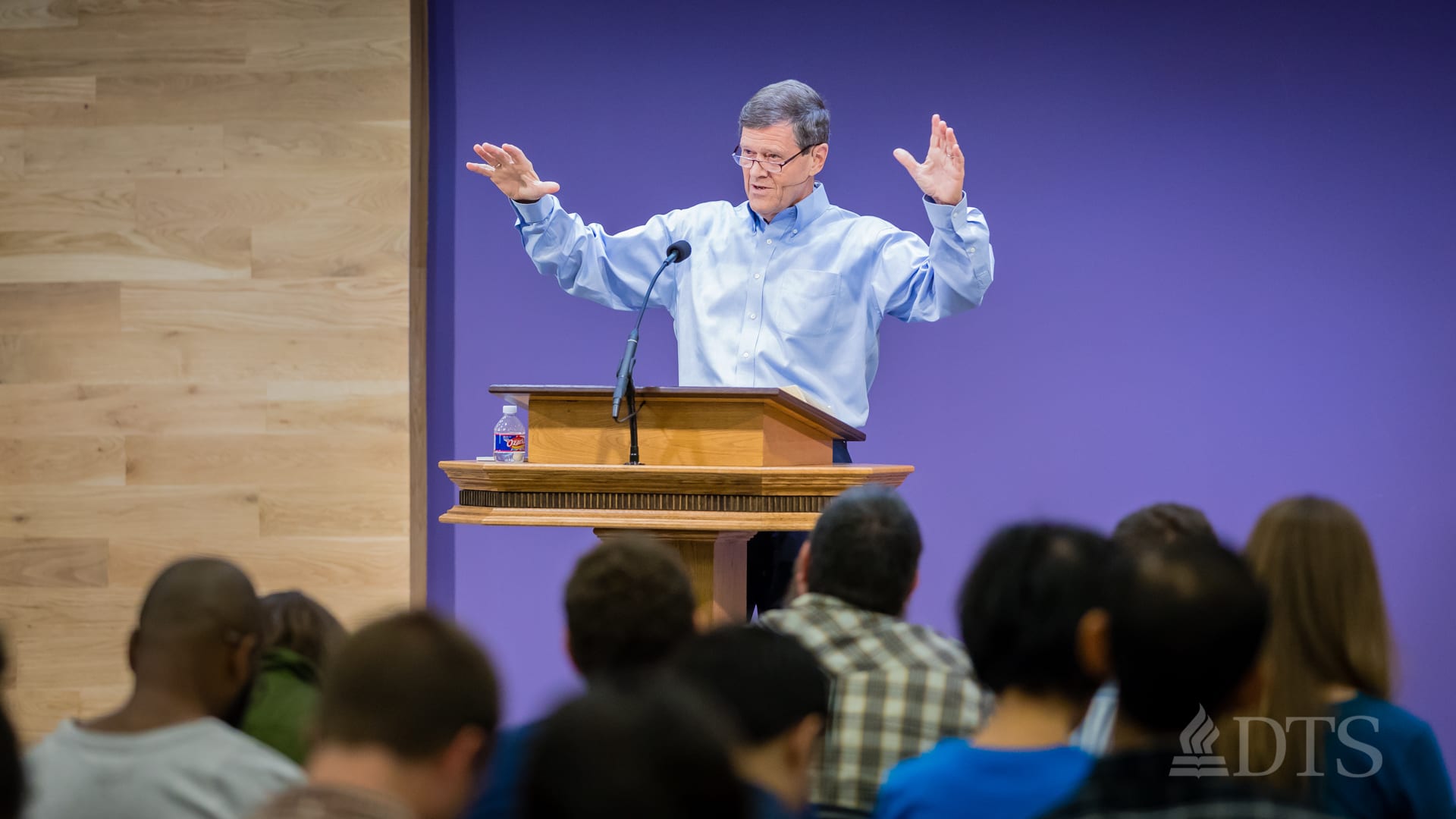 man standing at podium speaking at DTS Chapel