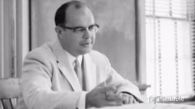 Professor Hendricks seated at desk teaching