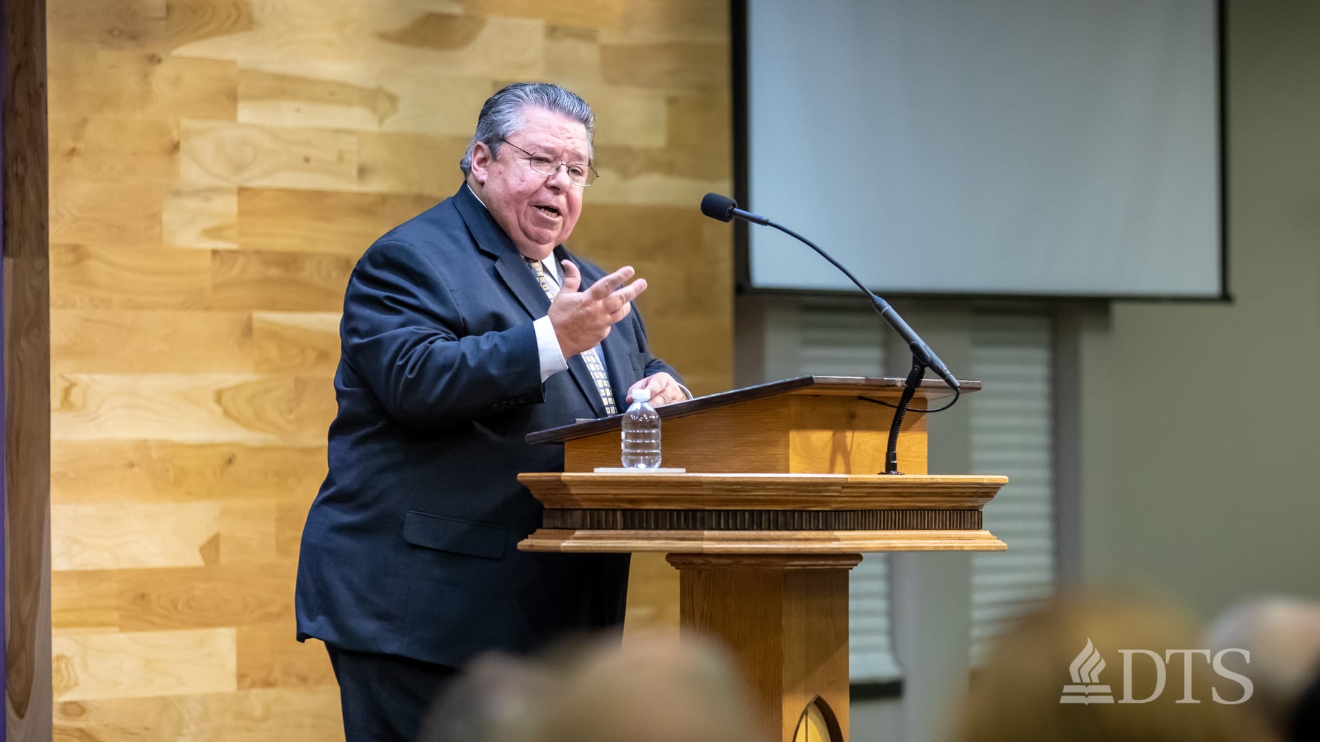 Dr. Mark Bailey standing at podium speaking at DTS Chapel