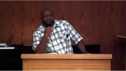 man standing at podium speaking at DTS Chapel
