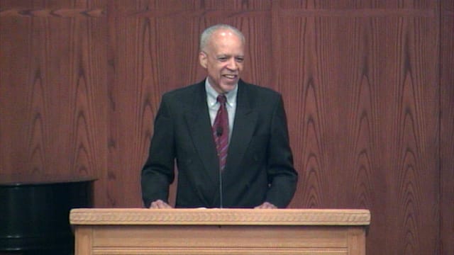 man standing at podium speaking at DTS Chapel