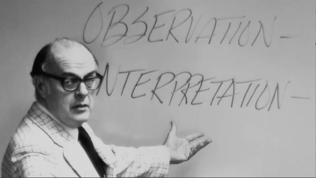 Dr. Howard Hendricks teaching using a whiteboard