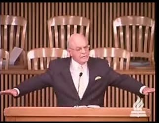 man standing at podium speaking at DTS Chapel