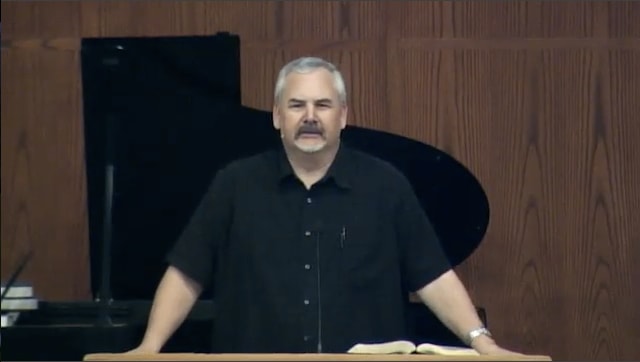 man standing at podium speaking at DTS Chapel