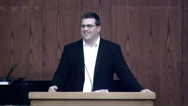 man standing at podium speaking at DTS Chapel