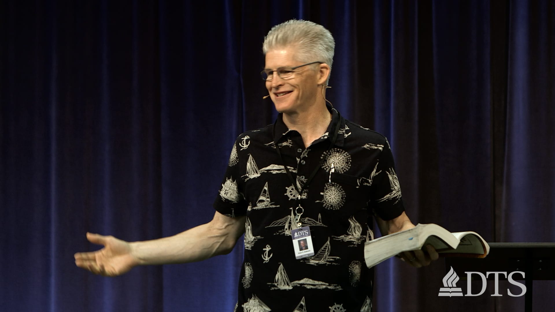 man standing in front of podium speaking at DTS Chapel
