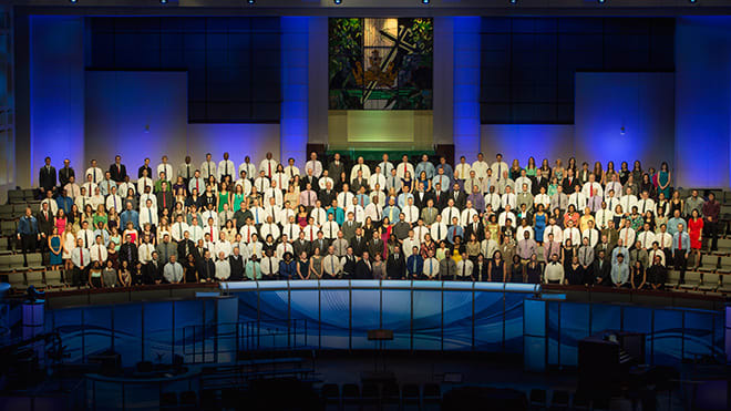 Graduates standing in Prestonwood Choir Loft prior to commencement