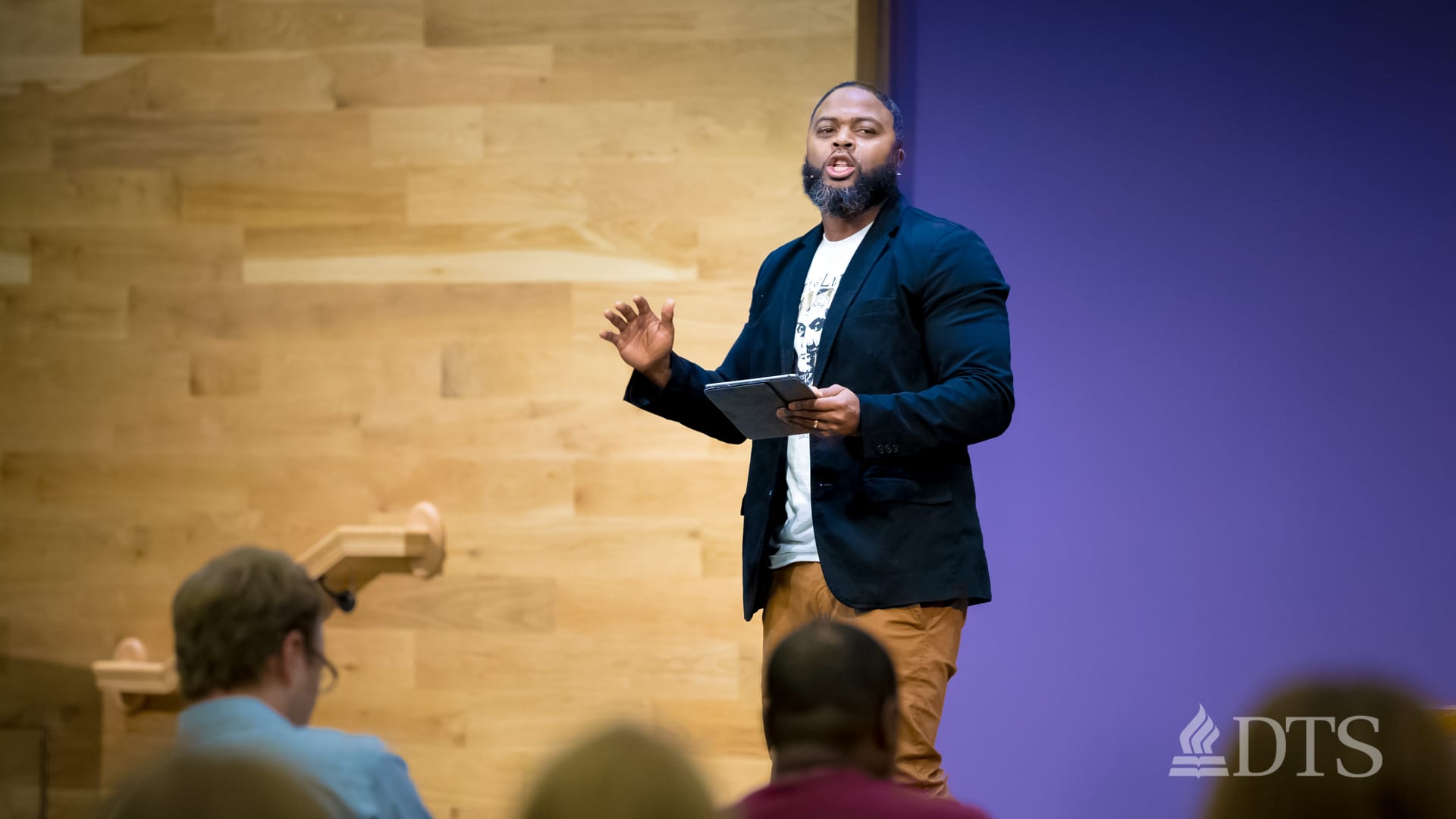 man standing on stage speaking at DTS Chapel