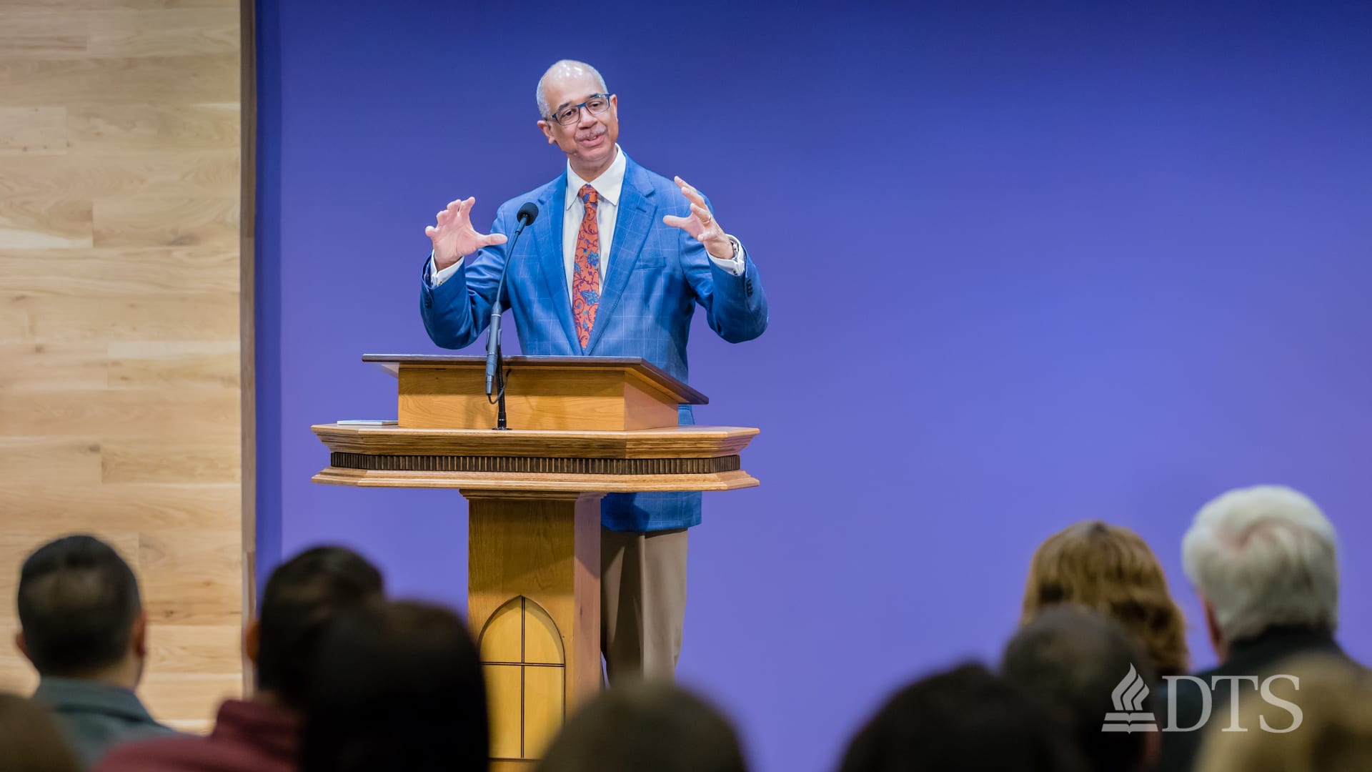 man standing at podium speaking at DTS Chapel