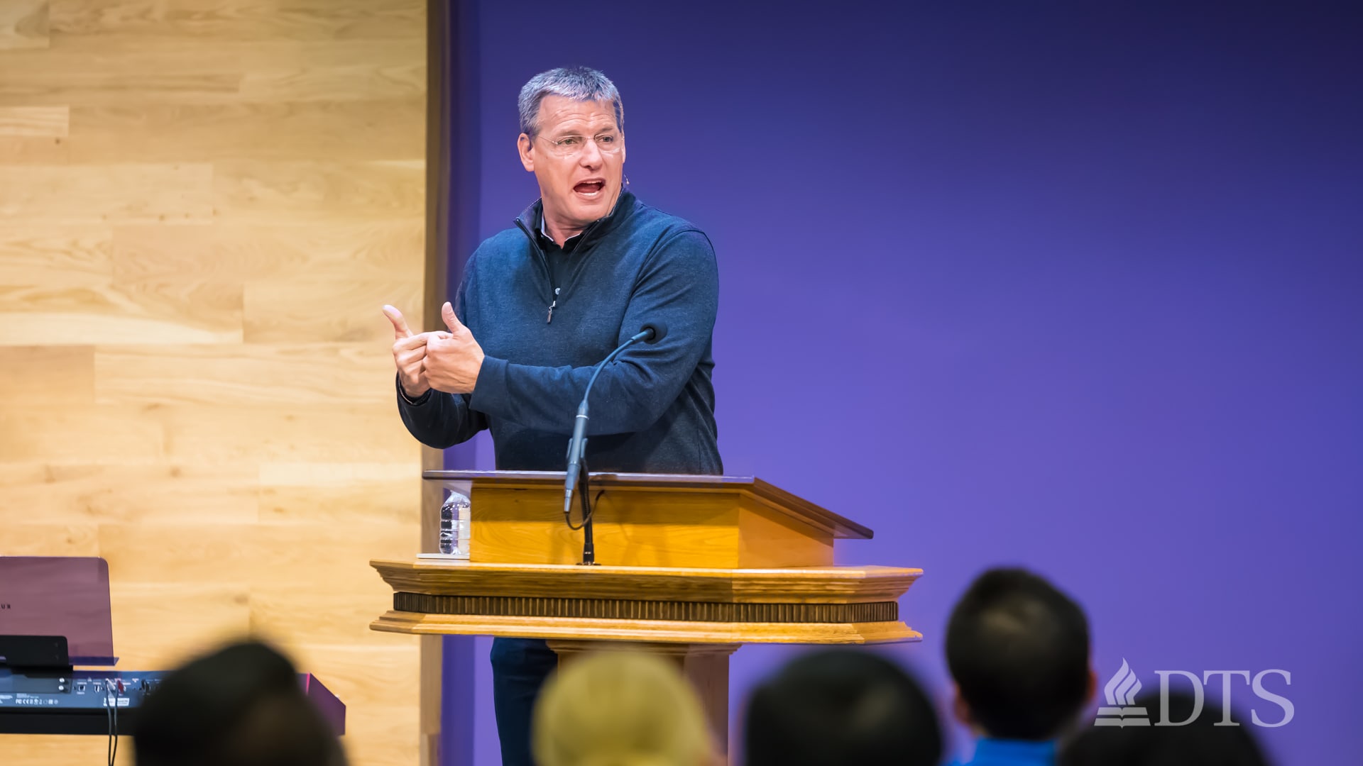 man standing at podium speaking at DTS Chapel
