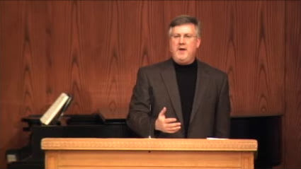 man standing at podium speaking at DTS Chapel