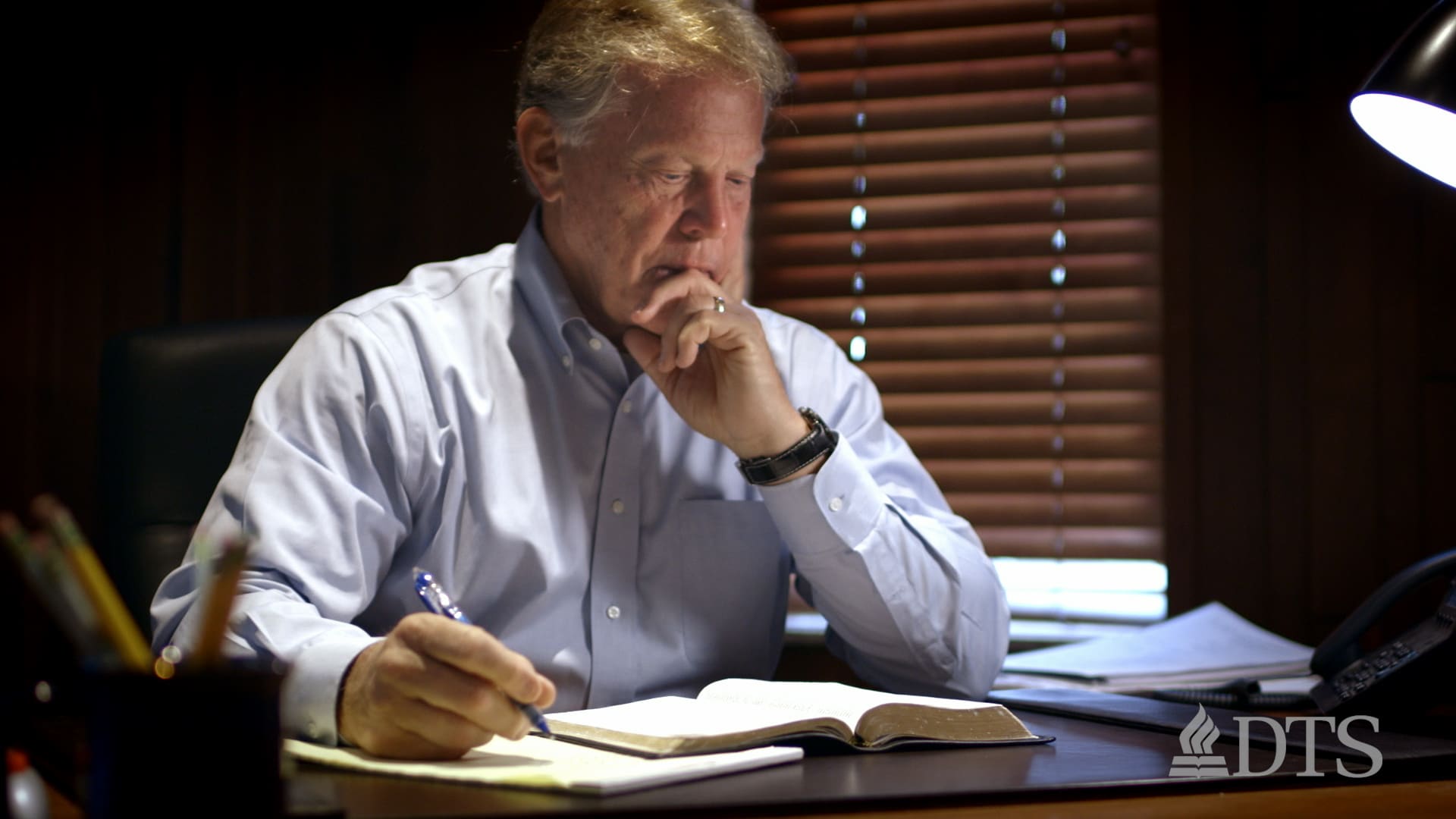 Joe Stowell seated at his desk studying the Bible