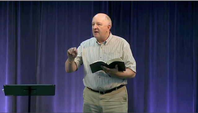 man standing at podium speaking at DTS Chapel