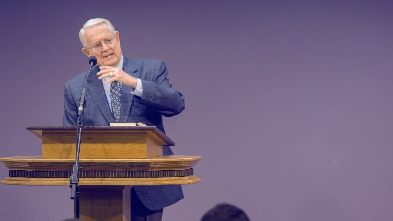 Dr. Swindoll standing at a podium and speaking into a microphone
