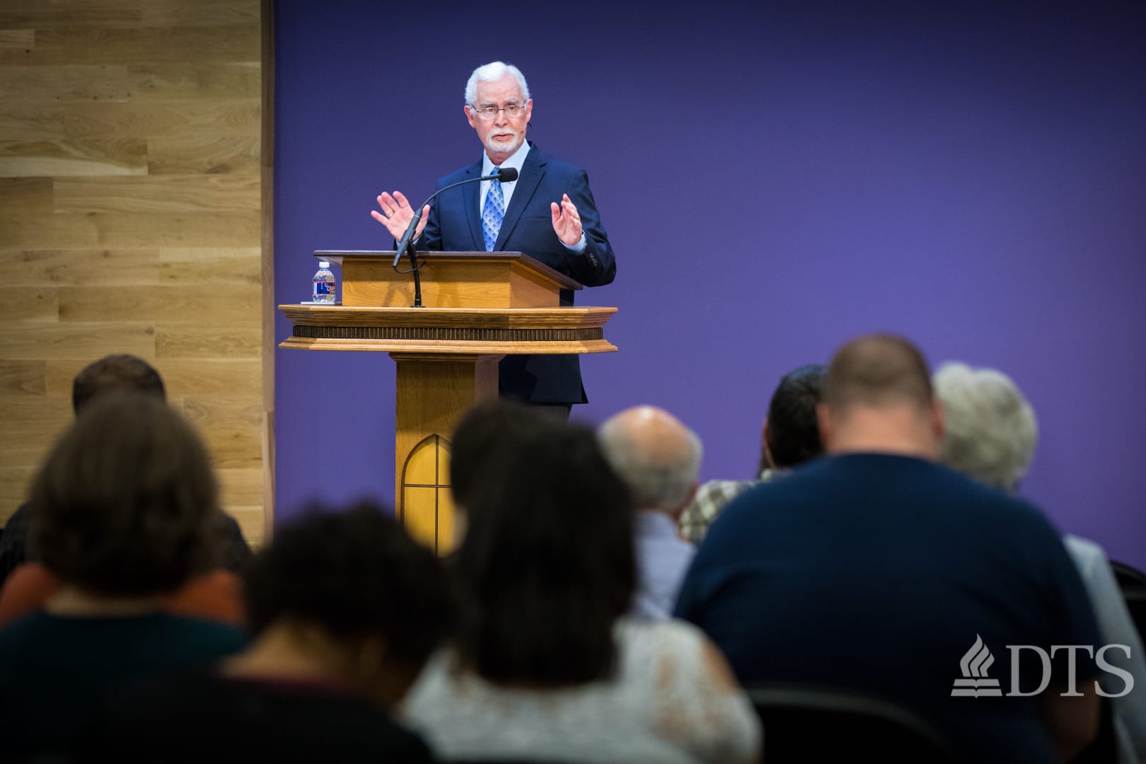man standing at podium speaking at DTS Chapel