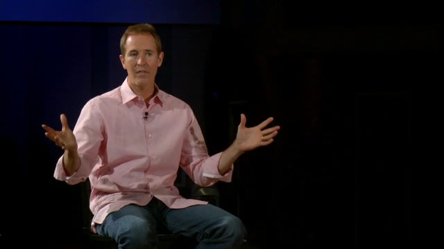Andy Stanley seated on dark stage talking