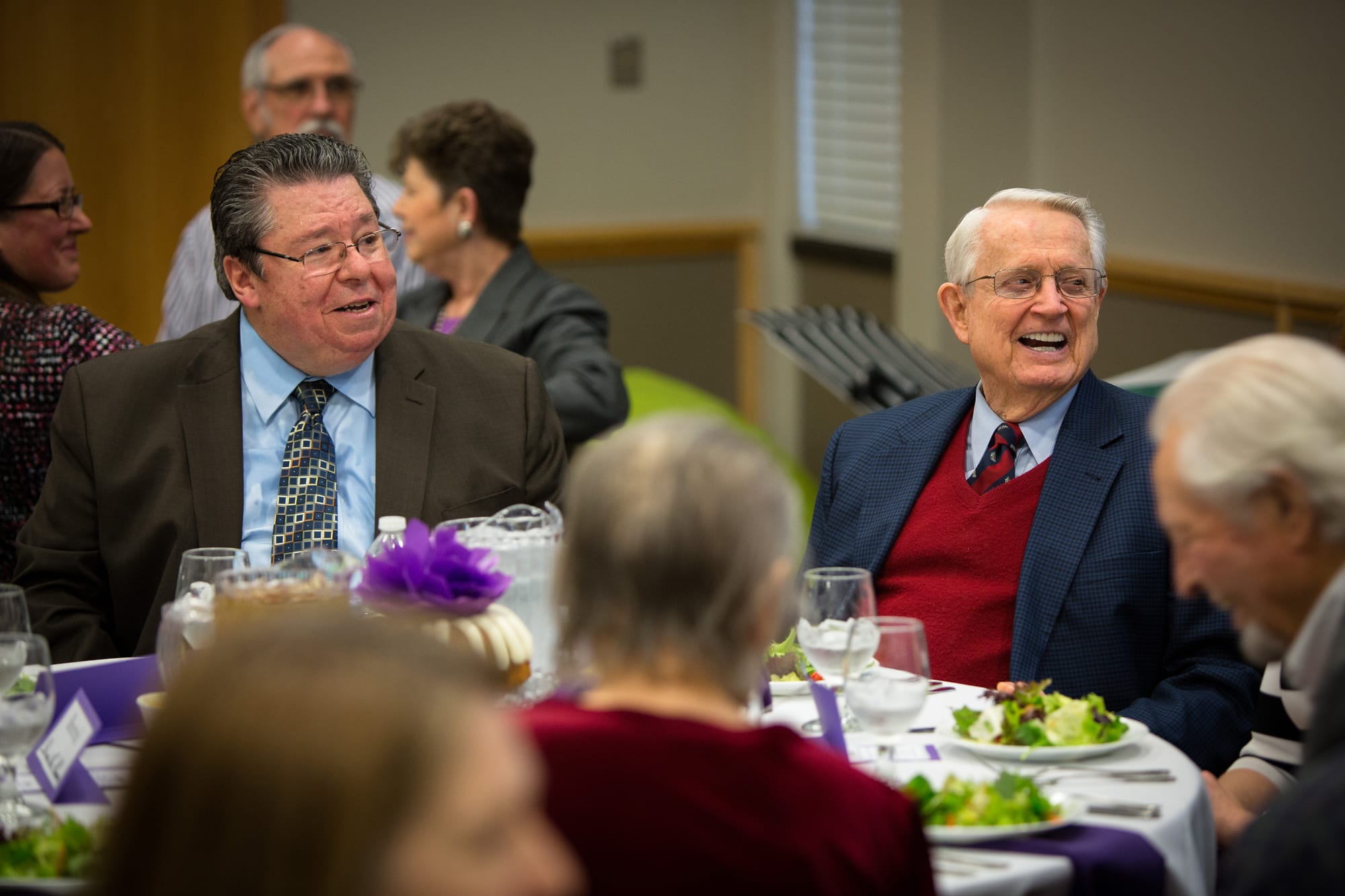 Dr. Mark Bailey seated next to Dr. Swindoll at a DTS event