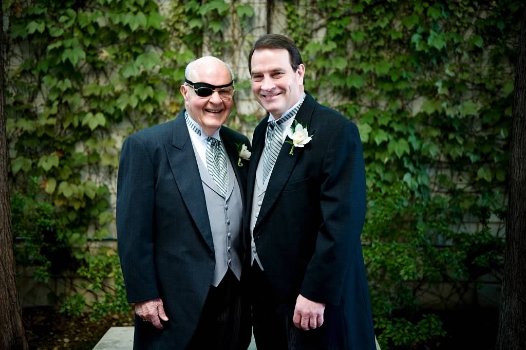 Bill Hendricks and Professor Hendricks dressed in wedding attire standing outdoors