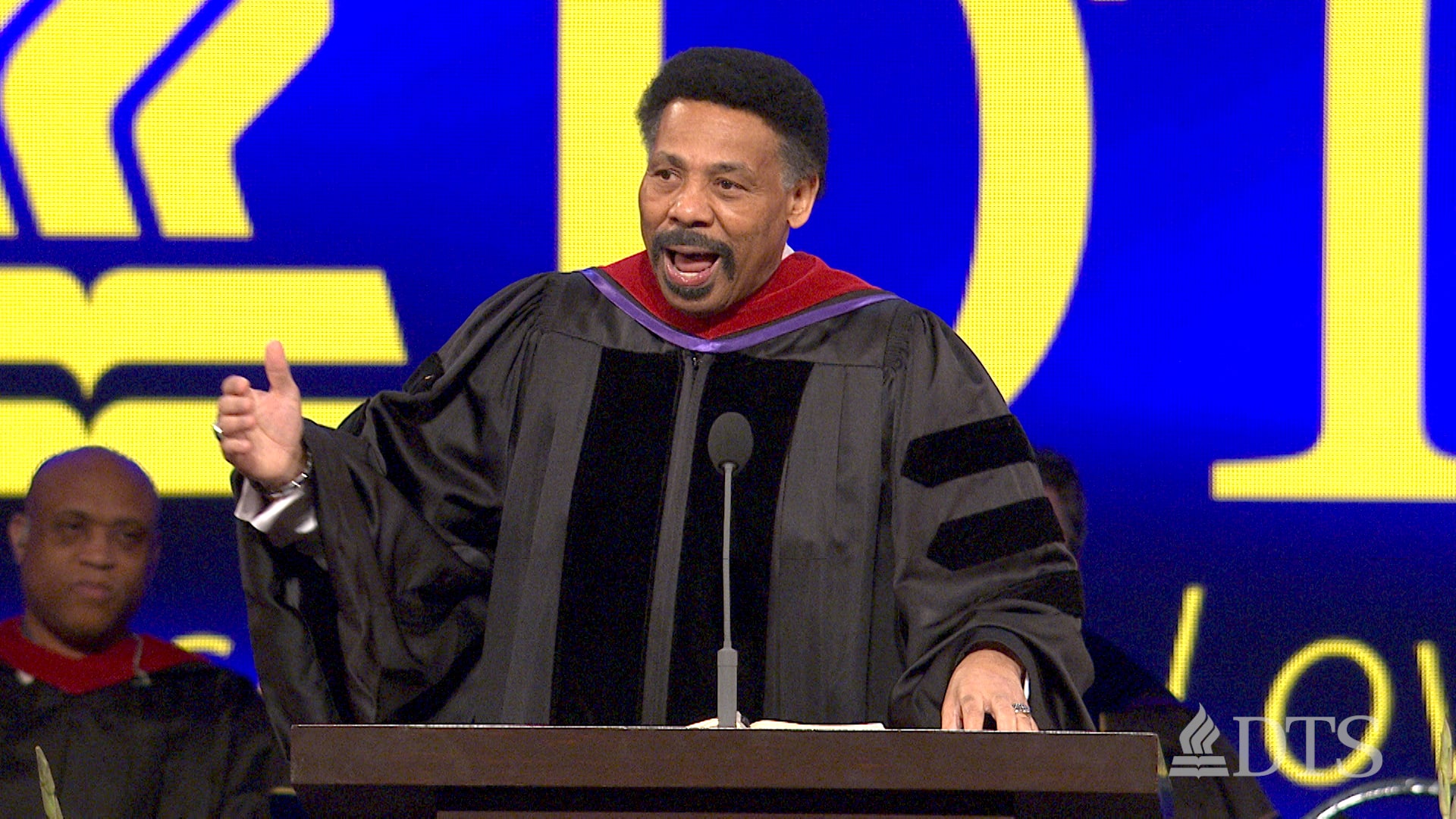 Dr. Tony Evans standing at a podium speaking during DTS commencement