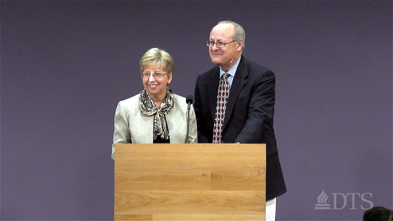 Nancy and David Writebol speaking at the podium during DTS Chapel