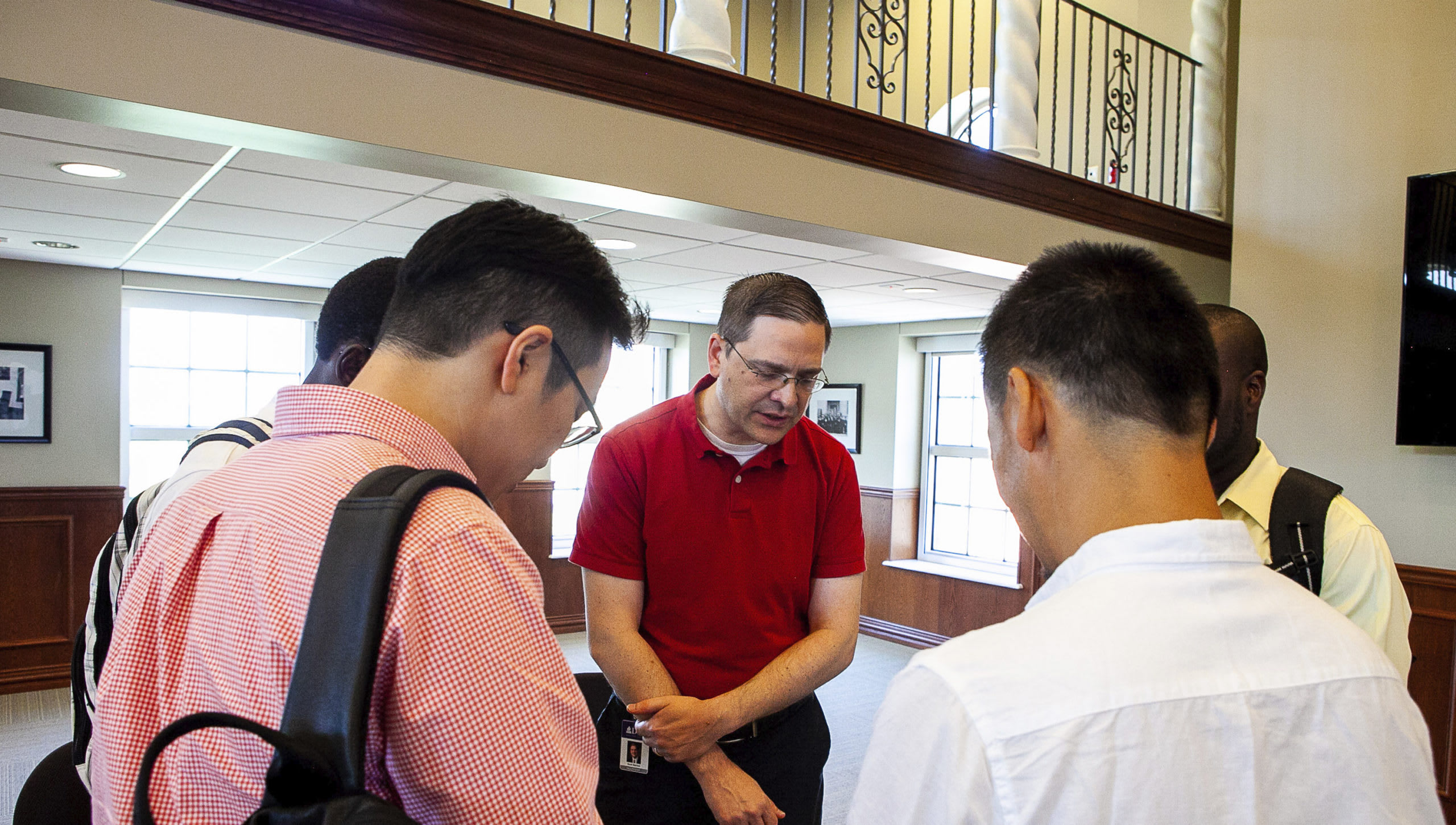 Dr. Barfoot praying with students