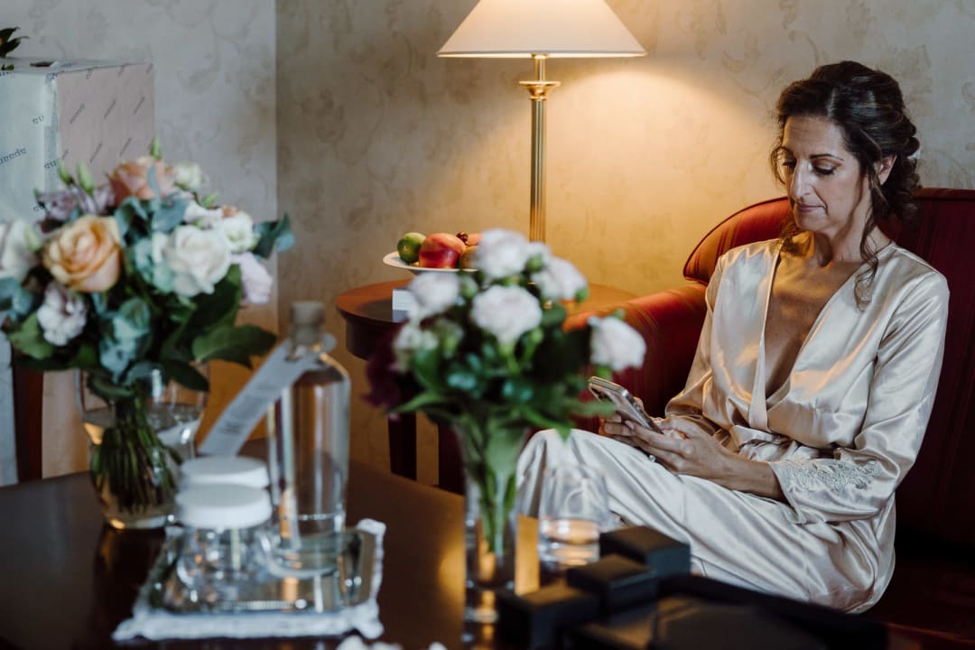 Bride sitting quietly in her room before her intimate elopement day begins.