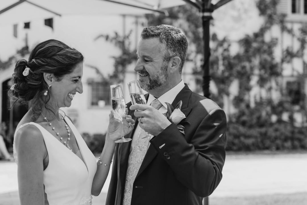 Newlyweds sharing a toast after their intimate wedding ceremony.