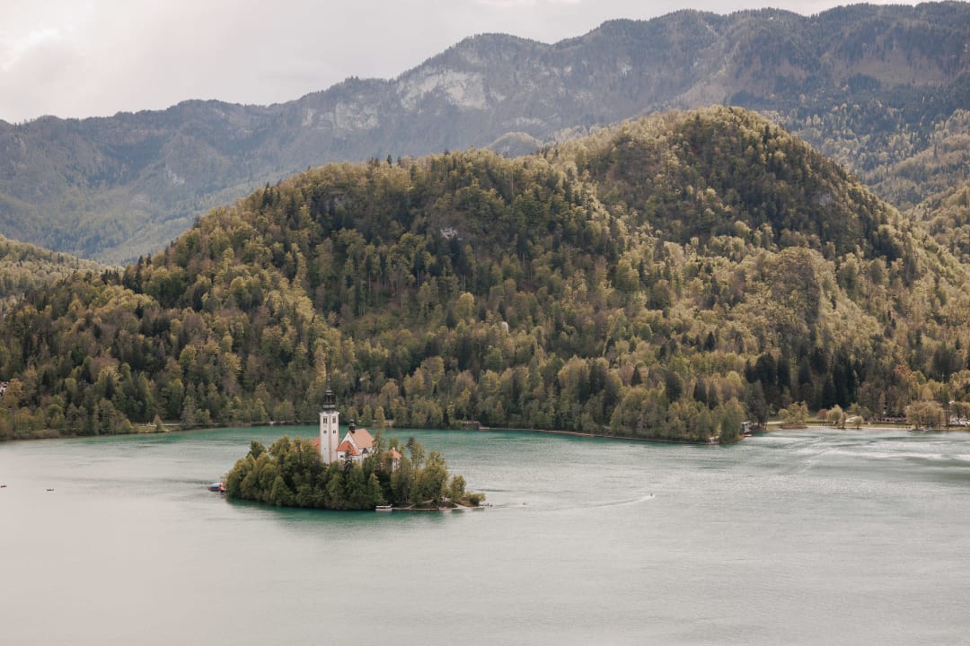 Serene view of Lake Bled with the island church in the distance — the ceremony backdrop.