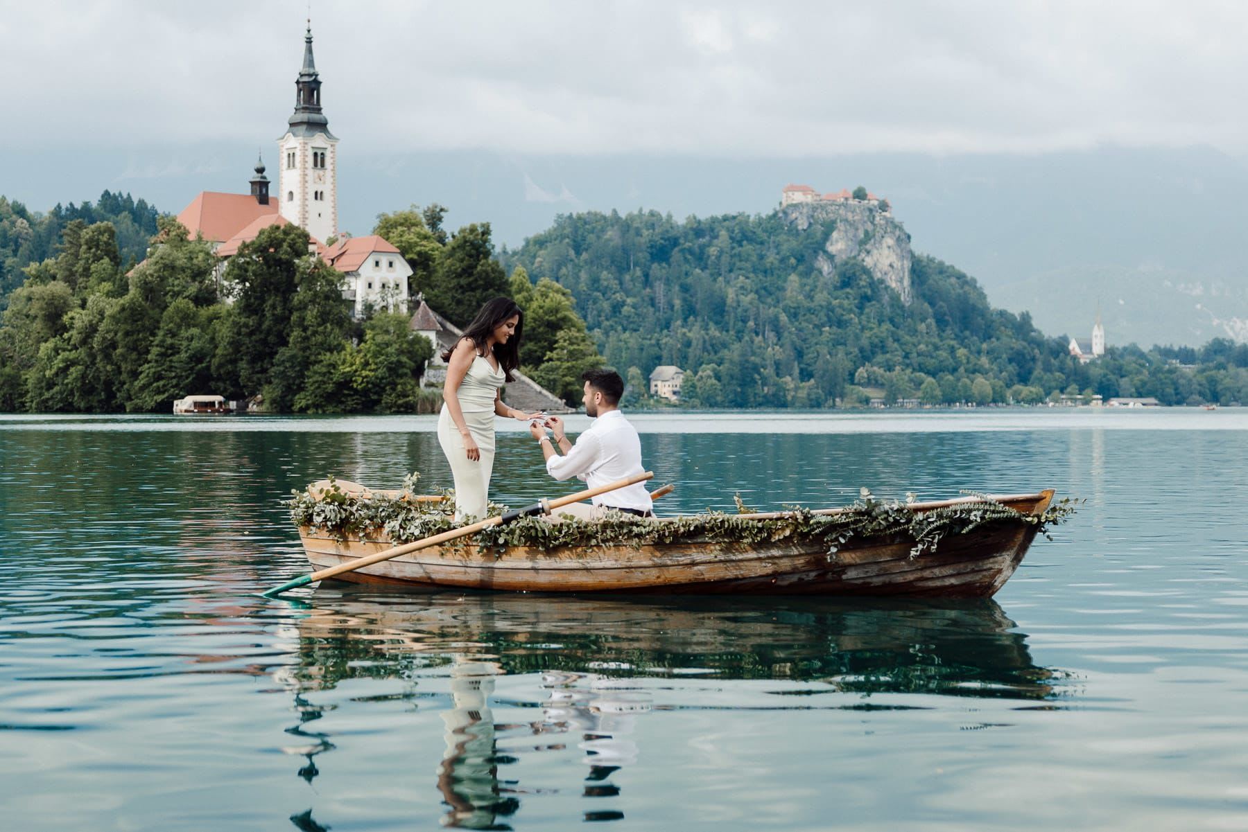Romantic boat proposal with Bled Island visible in the background.