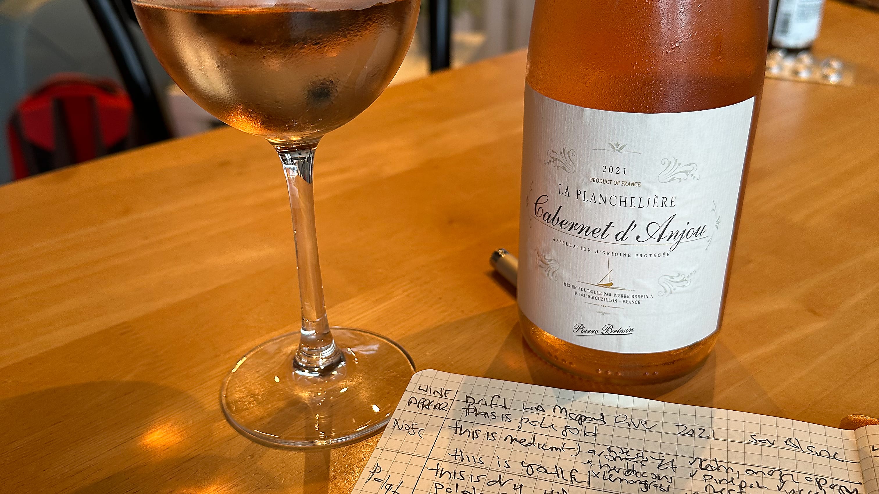 Cabernet d'Anjou bottle with a glass of wine Cabernet d'Anjou bottle with a glass of wine