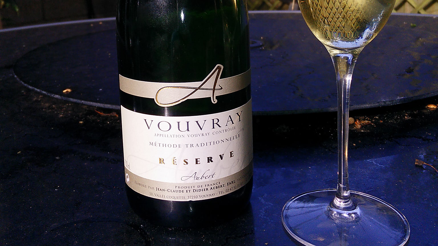 Vouvray sparkling bottle with a glass of wine Vouvray sparkling bottle with a glass of wine