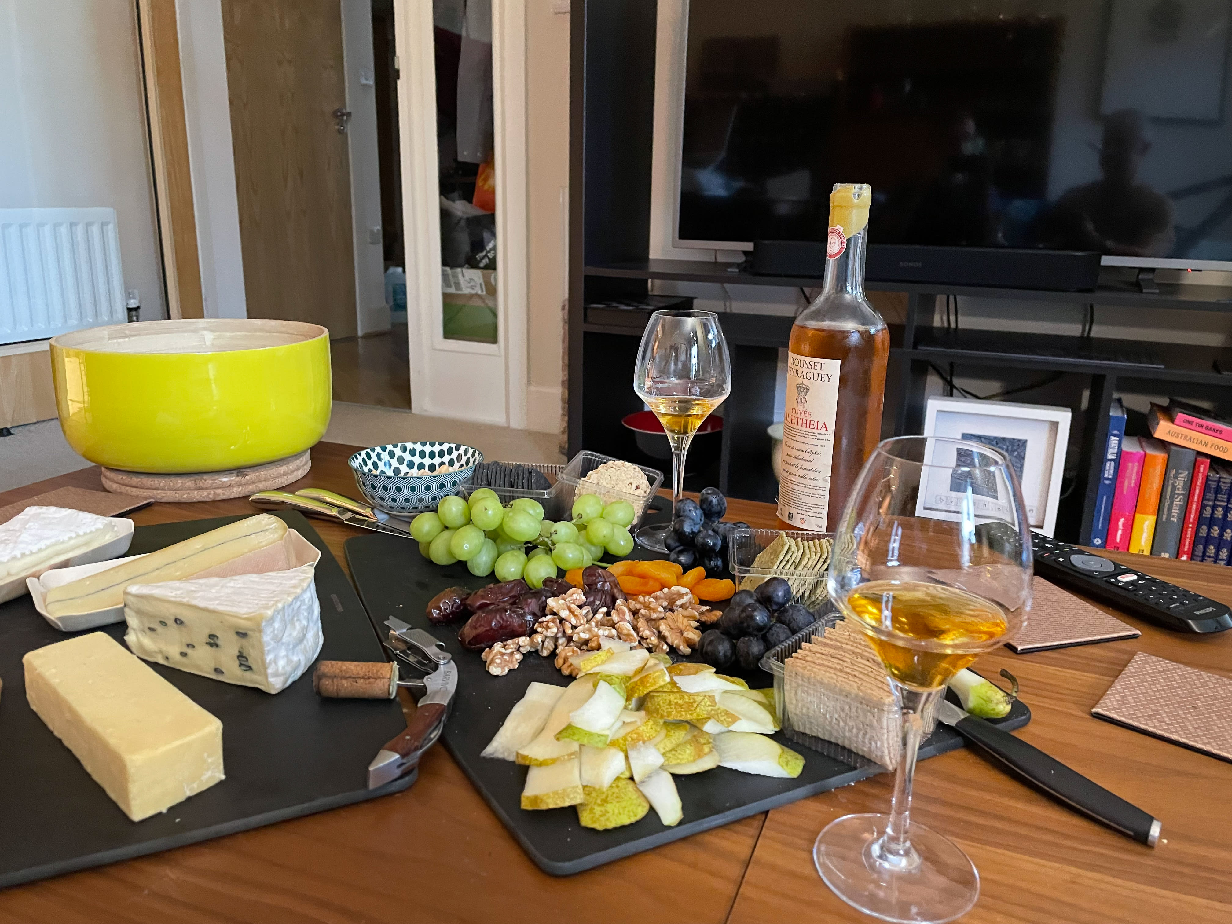 table with selection of cheese, fruit, crackers and sweet wine table with selection of cheese, fruit, crackers and sweet wine