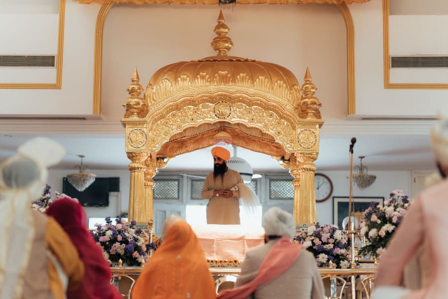 Gurdwara reception venue decorated for Punjabi wedding in Pune — documentary wedding film and photography by FineShot Weddings