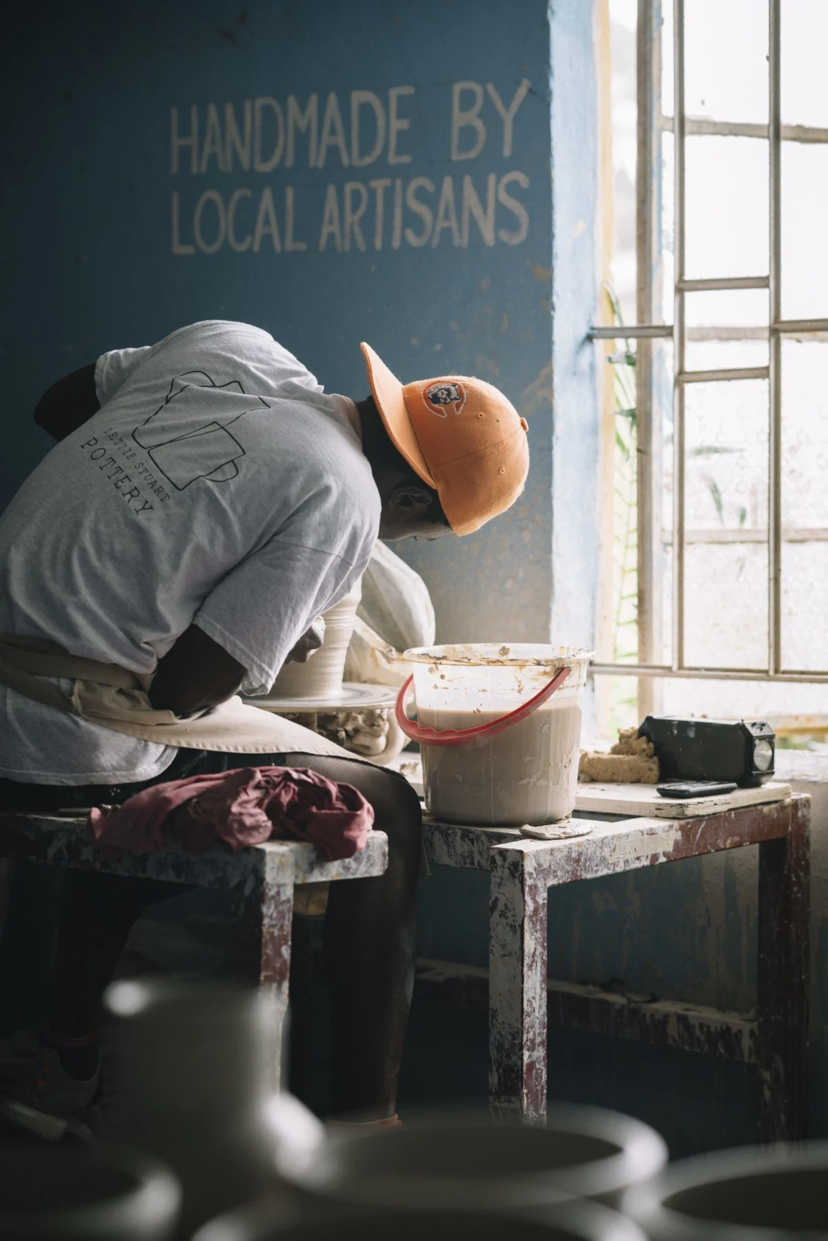 Julius a potter at the lettie stuart pottery sierra leone throwing using kickwheel method