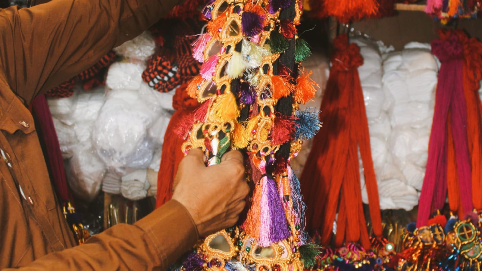 A shopper choosing festive decorations at a market stall