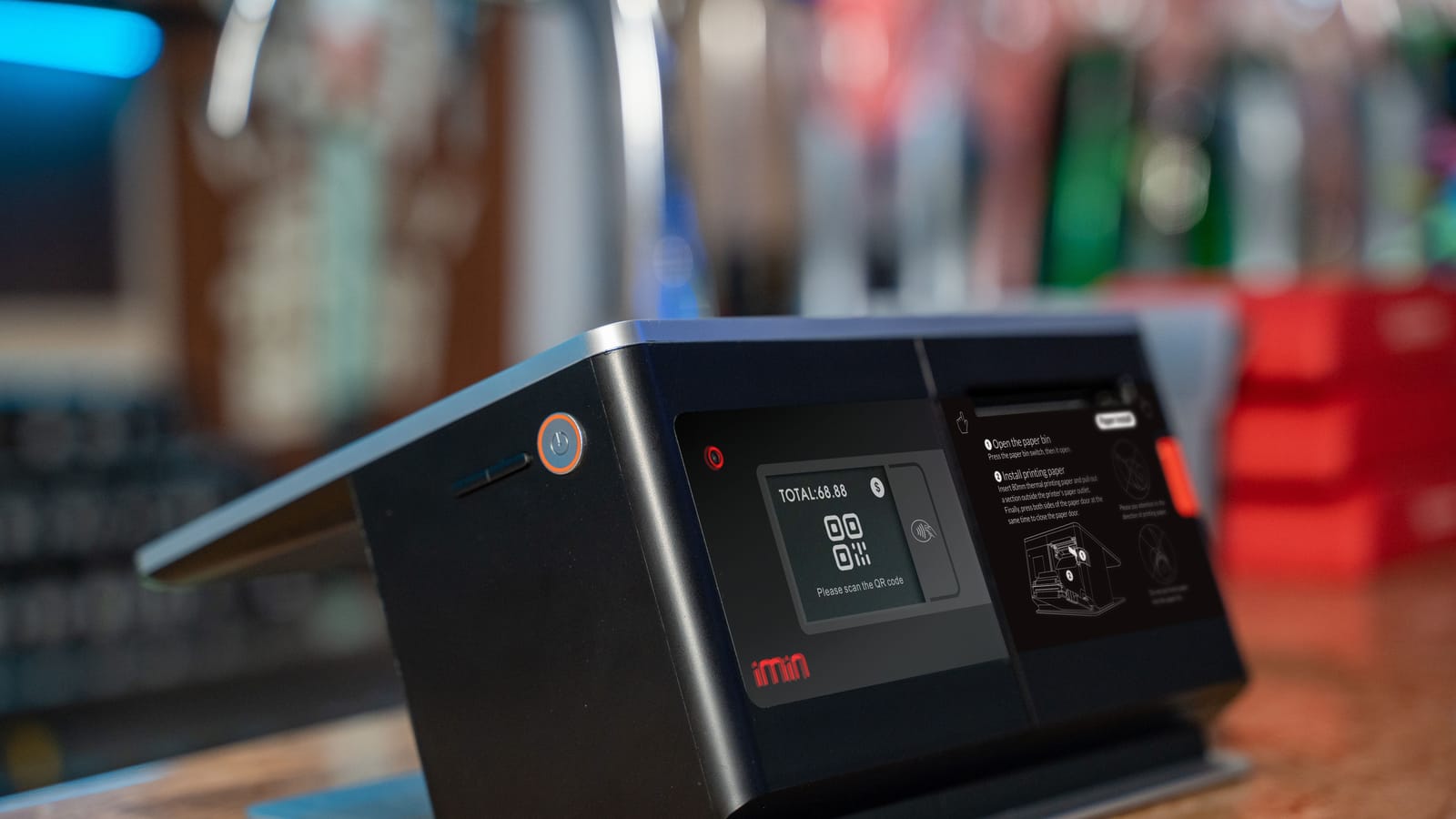 A touchscreen point-of-sale terminal with a built-in printer on a shop counter
