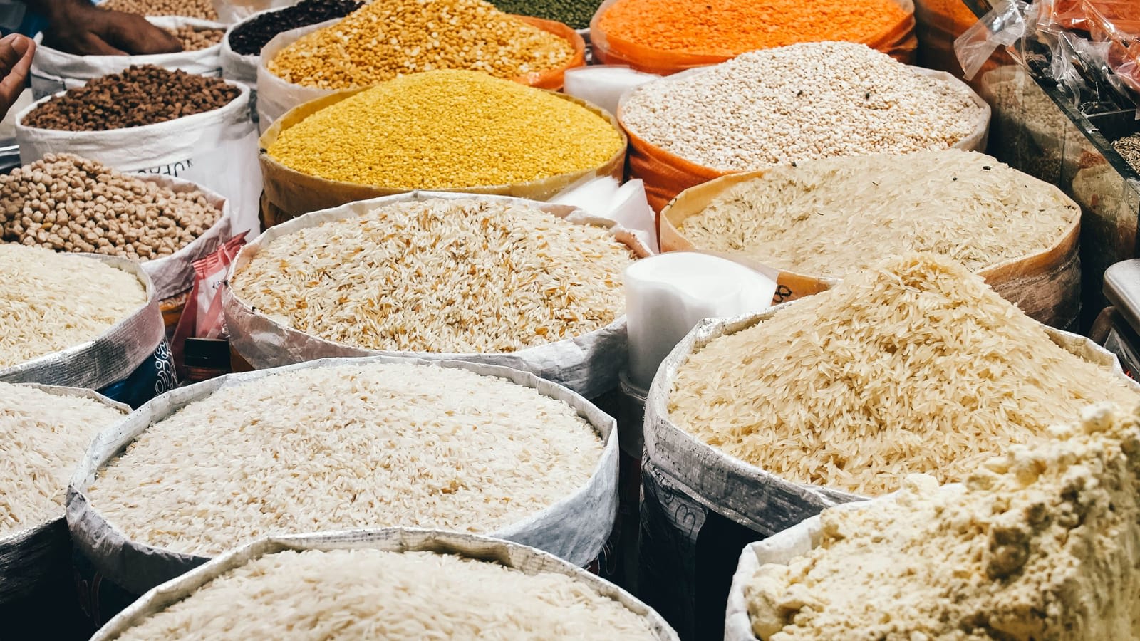 Open sacks of rice, lentils and grains for sale at a market stall in Sindh