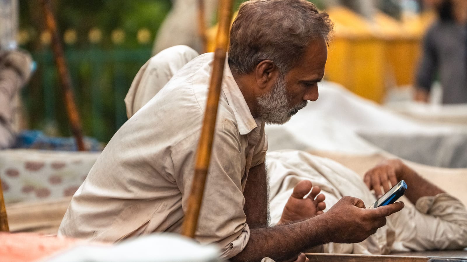 A man in Karachi reading messages on his phone