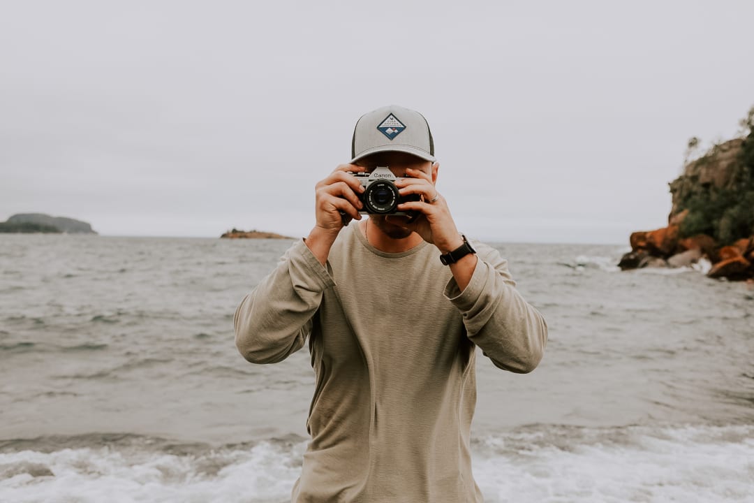 Josh Wicklund photographing along the Lake Superior shoreline