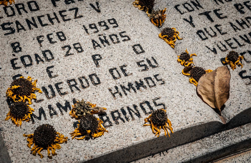 Dried marigolds on a headstone in Los Mochis area cemetery, Sinaloa.