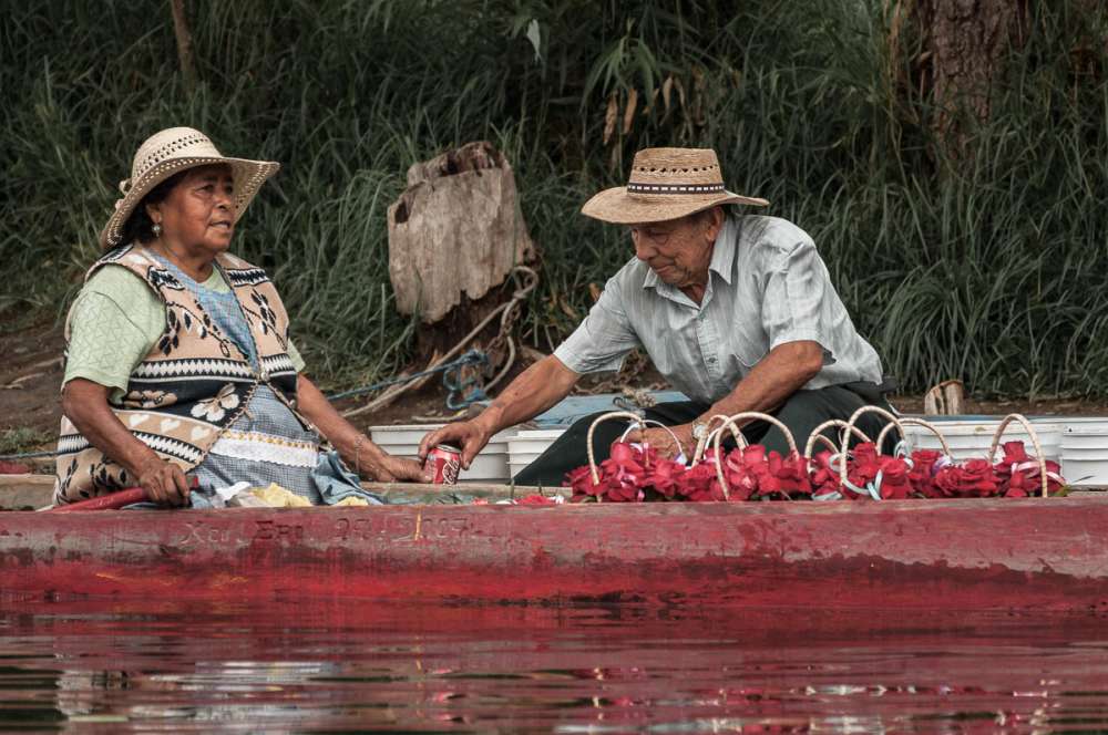 Couple sharing a coke at Xochimilco.