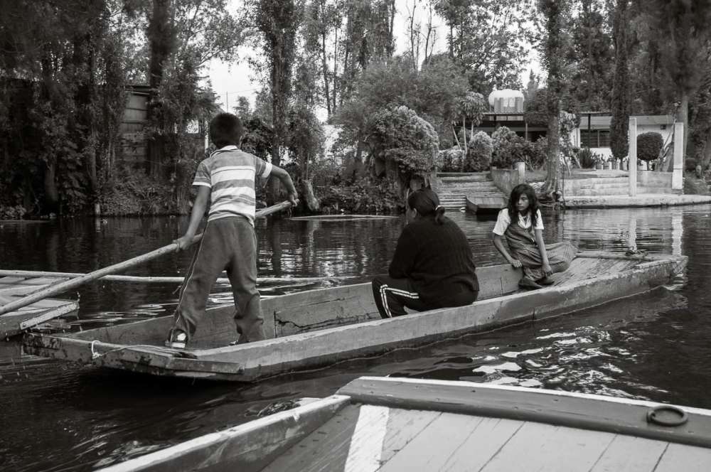 A girl commuting to school by boat at Xochimilco.