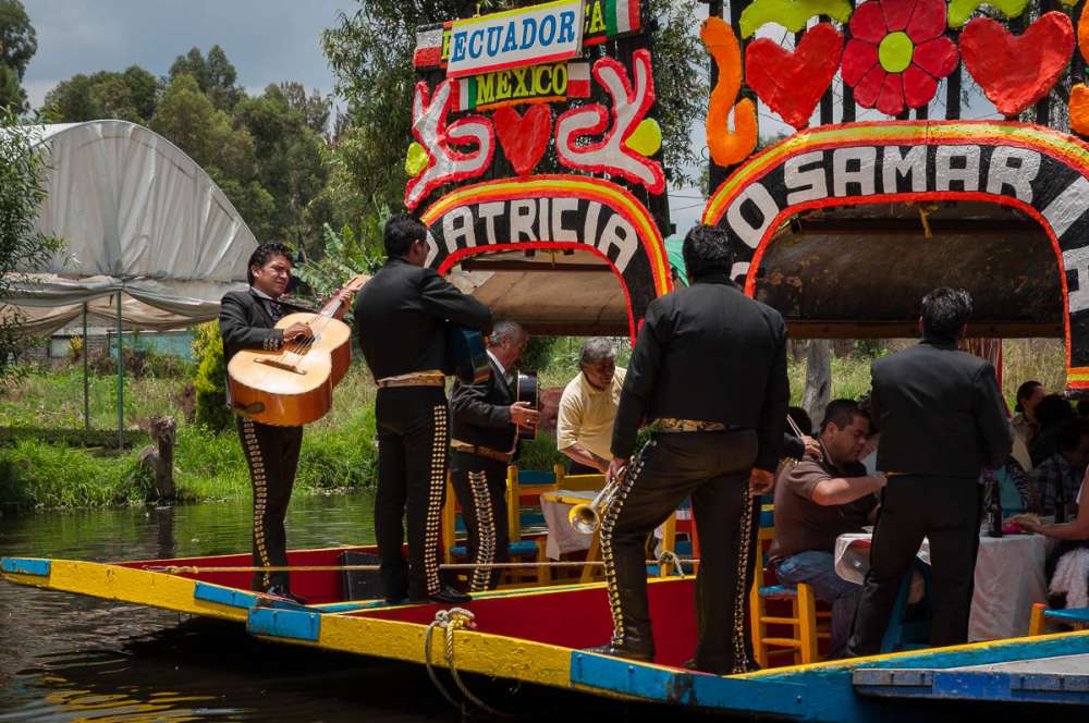 Musicians playing for passengers on trajineras at Xochimilco.