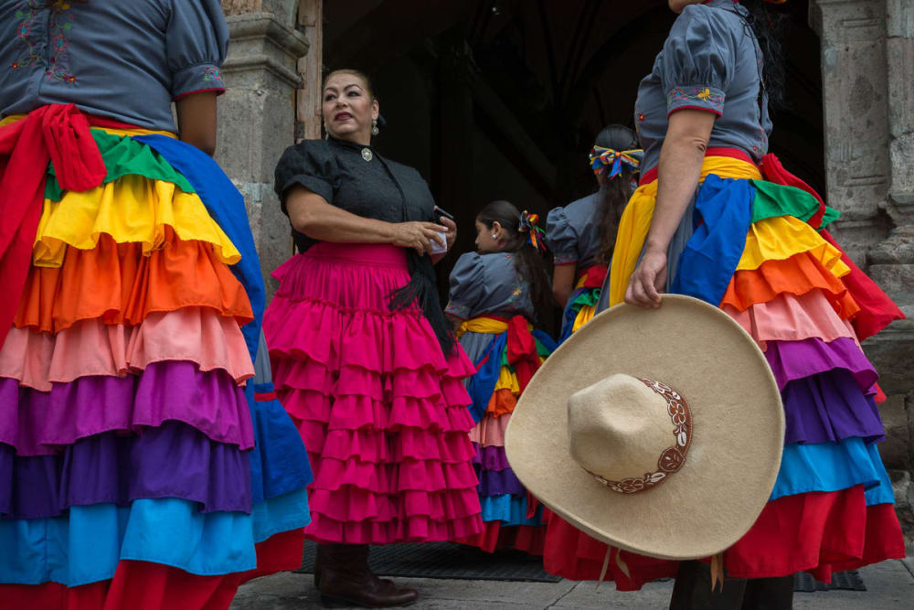 Escaramuza cowgirls wait to enter the church before mass.