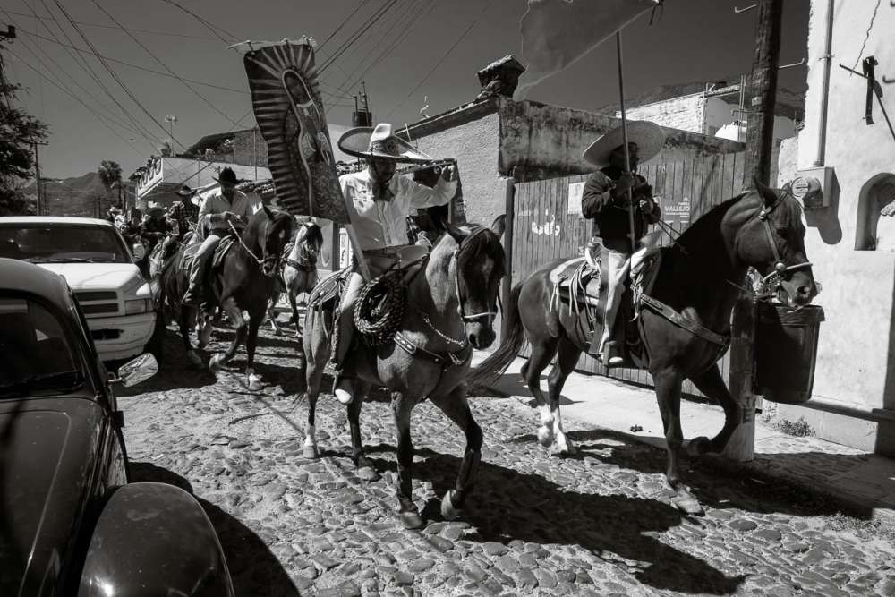 Cowboys during a procession for a quinceañera in Mexico.