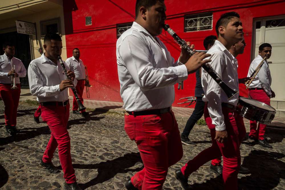 Banda with matching red pants play music in Jalisco.