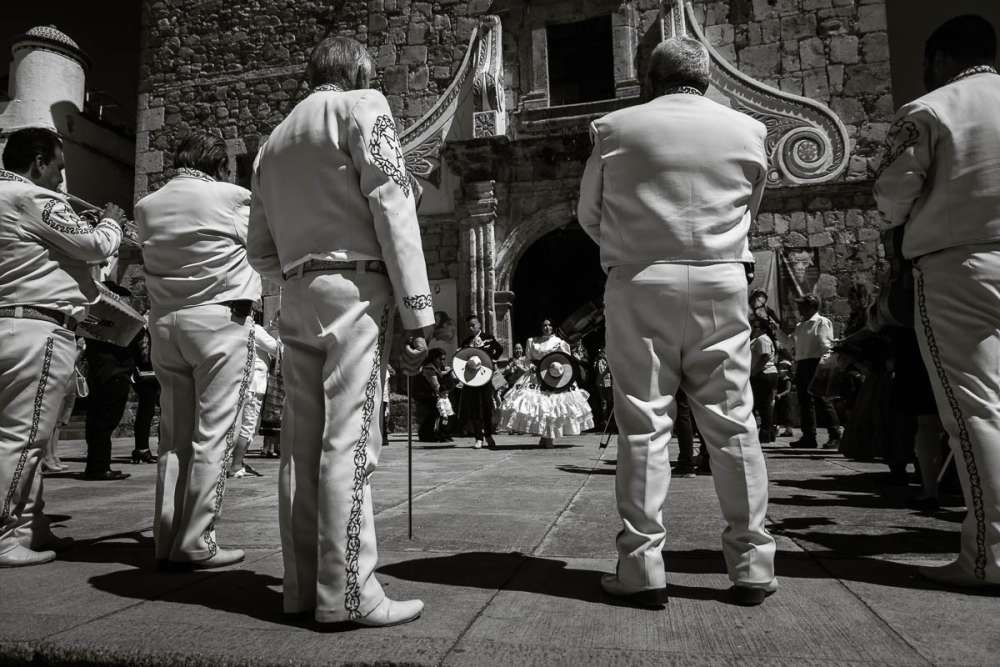 Mariachi group playing outside church after quinceañera ceremony in Mexico.