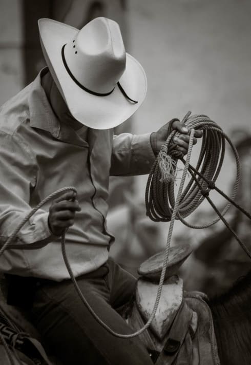 A cowboy practices his roping skills in the bullring.