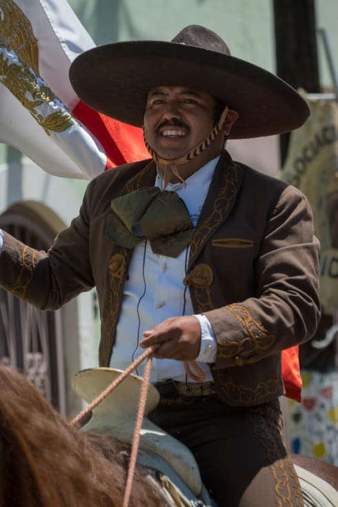 Juan Flores holds the Mexican flag during the parade.