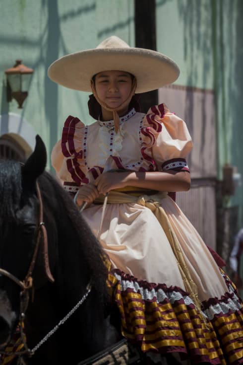 Gaby Gucho on her horse during the parade for el Día del Charro.